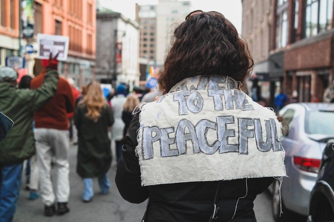 Climate activist holding a hand-drawn placard during a peaceful gathering