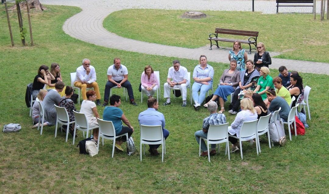 Peace dialogue circle of diverse adults in soft daylight