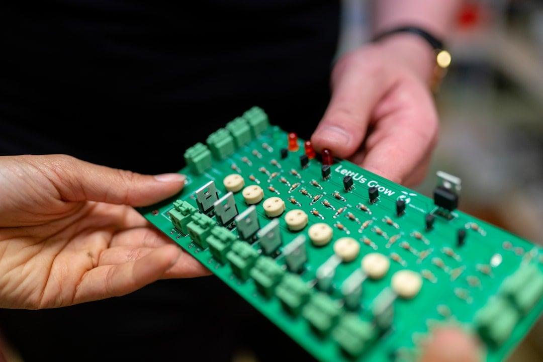 Engineer working on a circuit board prototype in a workshop